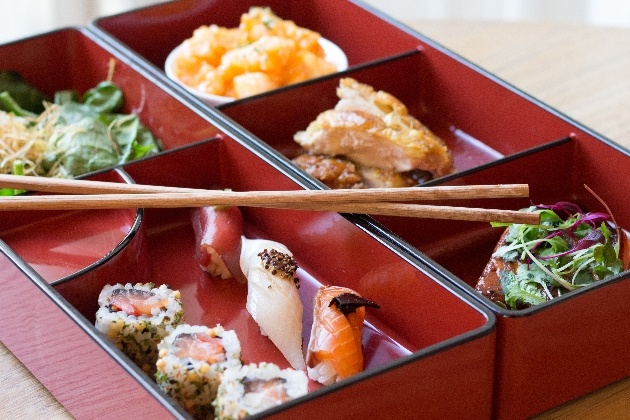 closeup of sushi presented in nice bowl with chopsticks