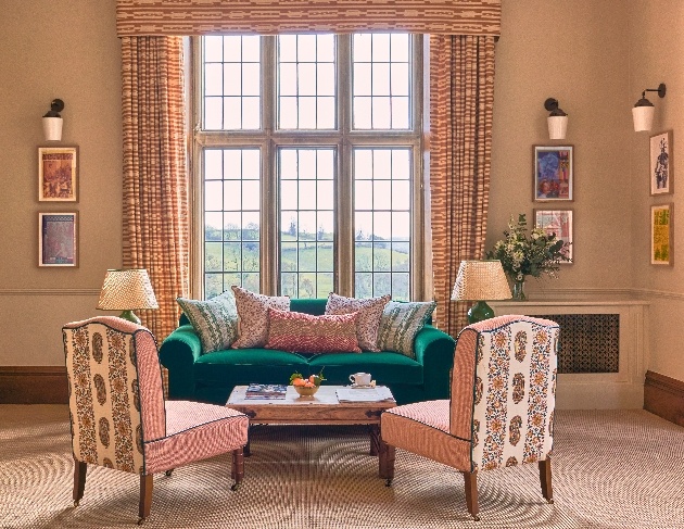 sofa and chair in front of large window