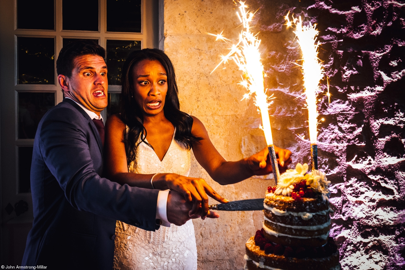 couple cutting cake with a firework in it 