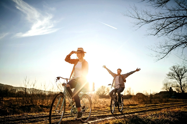man and woman riding bikes in the sun