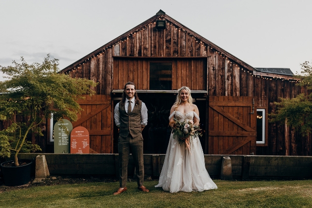 Couple infront of barn