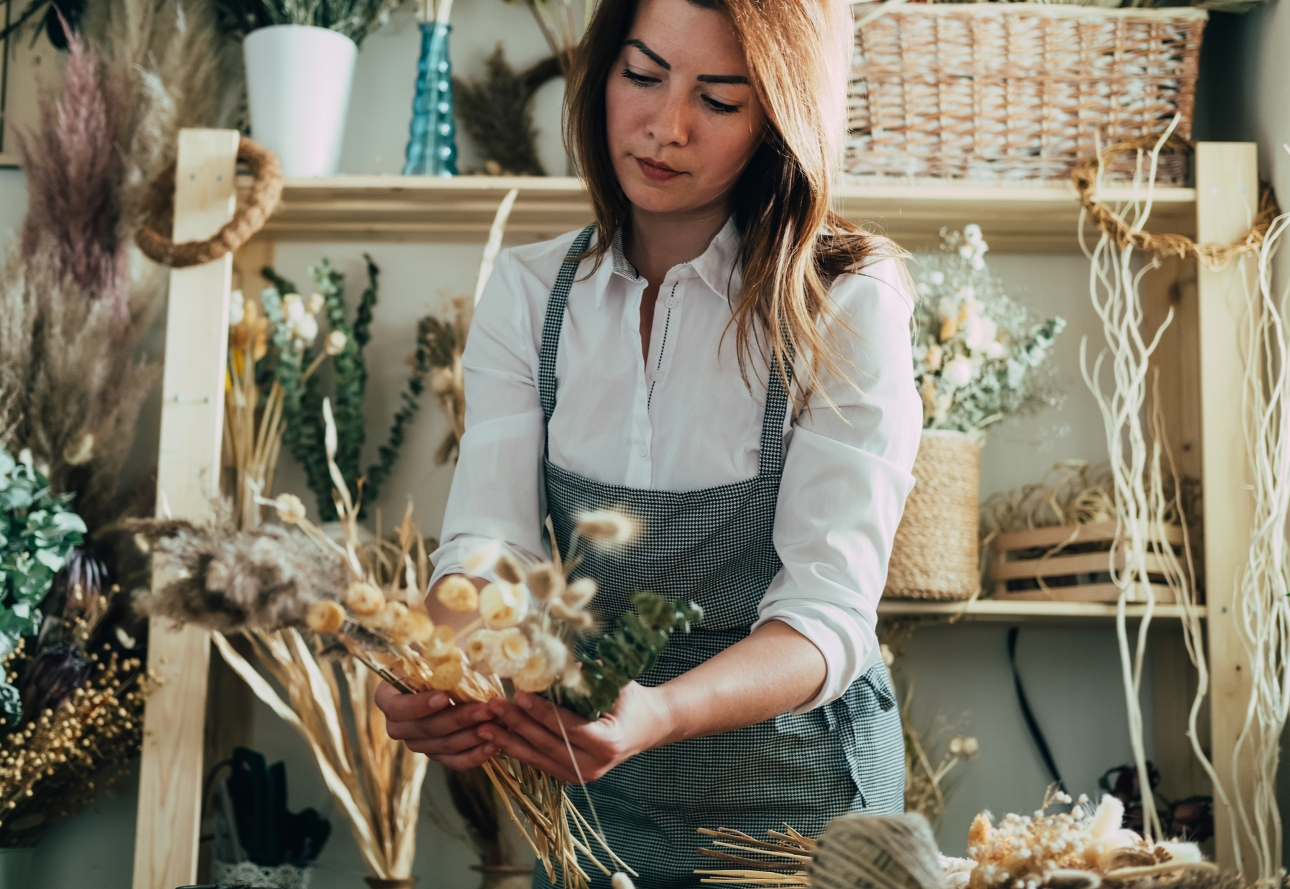 florist creating bouquet of dried flowers