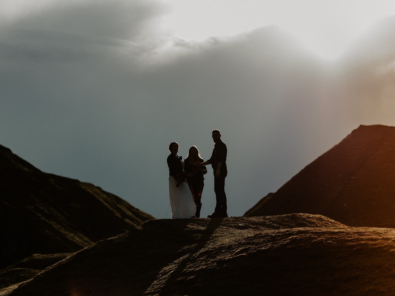 couple standing on a mountain saying their vows