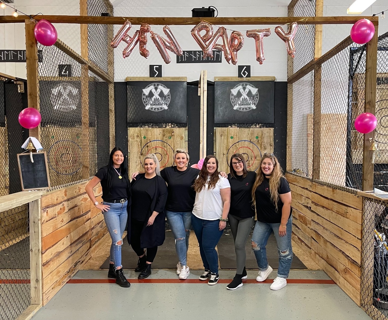 group of women standing at an axe throwing event at a hen do