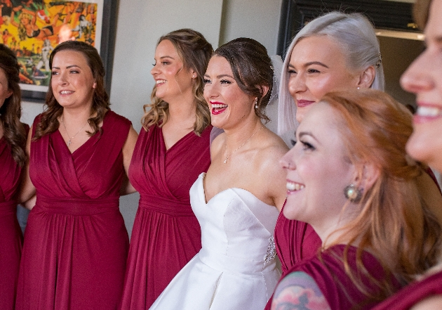 bridesmaid and bride group in pink dresses hair and makeup