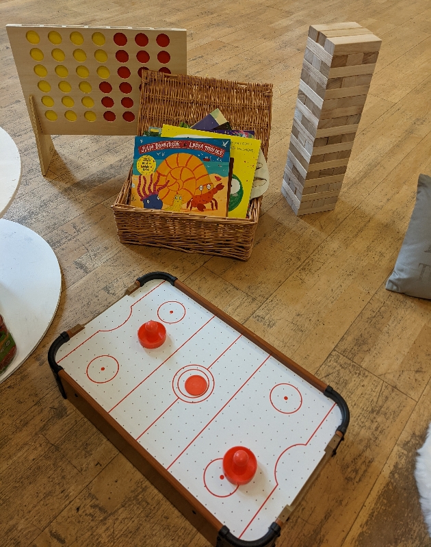 large wooden jenga, connect four and basket of books