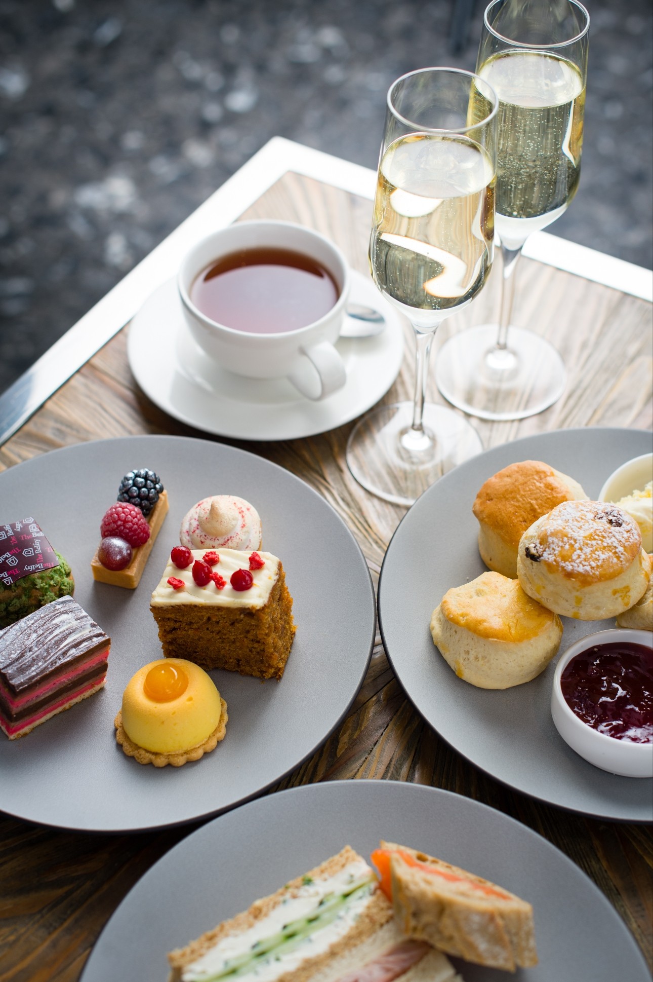 afternoon tea with sandwiches, cake, and fizz