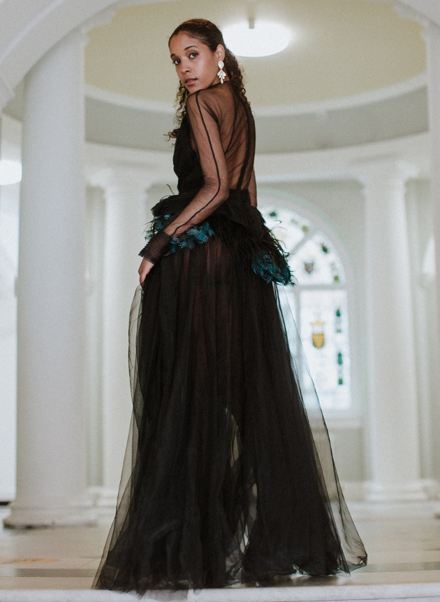 model in black coloured wedding dress with sheer back