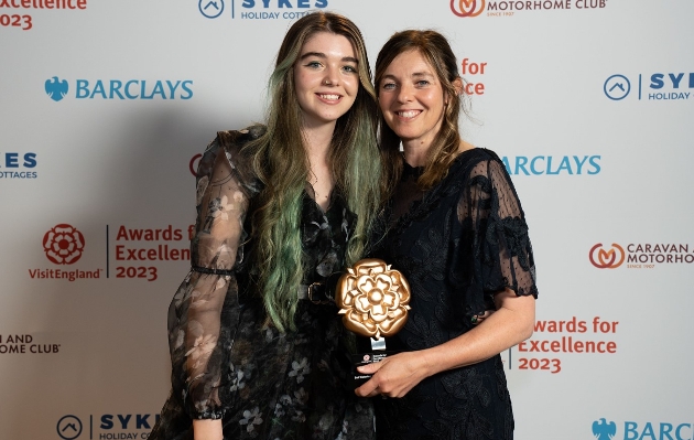 two women holding award 