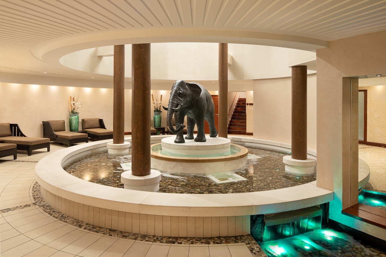 indoor chill out area with pillars, grey elephant, running water feature