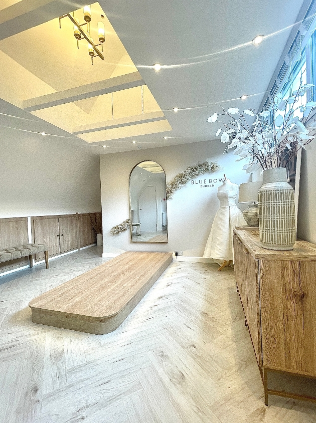 showroom with wooden catwalk mirror neutral colours